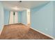 Another angle of the finished basement highlighting the neutral carpeting and window at 12025 Monaco Dr, Brighton, CO 80602