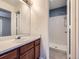 Bathroom featuring a sink with vanity and a shower behind a doorway at 12025 Monaco Dr, Brighton, CO 80602
