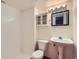 Cozy bathroom featuring a pedestal sink, tiled shower, and a mirrored medicine cabinet at 12025 Monaco Dr, Brighton, CO 80602