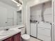 A clean bathroom offers a washer and dryer combo, with ample storage space at 12025 Monaco Dr, Brighton, CO 80602