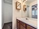 A bathroom features a vanity and closet and a mirror above the sink at 12025 Monaco Dr, Brighton, CO 80602