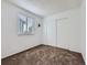 A bedroom has a window that allows natural light and a sliding-door closet at 12025 Monaco Dr, Brighton, CO 80602