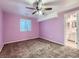 Bedroom featuring a fan, window, and a doorway that leads to the bathroom at 12025 Monaco Dr, Brighton, CO 80602