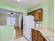 Kitchen with brown cabinetry and breakfast bar at 12025 Monaco Dr, Brighton, CO 80602