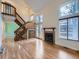 Open living space features wood floors, stairs, a fireplace, and large windows for plenty of natural light at 12025 Monaco Dr, Brighton, CO 80602