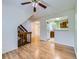 Open living room with staircase and view of kitchen at 12025 Monaco Dr, Brighton, CO 80602