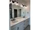 Elegant bathroom with double vanity, marble countertops, and sleek black fixtures at 203 Washington St, Erie, CO 80516