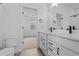 Modern bathroom featuring double vanity with marble countertop and black fixtures at 203 Washington St, Erie, CO 80516