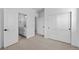 Bright bedroom with neutral carpet and doors to bathroom and closet at 203 Washington St, Erie, CO 80516