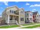 A quaint two-story home featuring a welcoming front porch and well-manicured lawn in a vibrant neighborhood at 203 Washington St, Erie, CO 80516