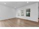 A bright, airy living room with light hardwood floors, white walls, and recessed lighting at 203 Washington St, Erie, CO 80516