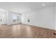 Spacious, light-filled living area featuring hardwood floors and fresh white walls and recessed lighting at 203 Washington St, Erie, CO 80516