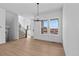 Sunlit living room featuring a modern light fixture and expansive windows with outside views at 203 Washington St, Erie, CO 80516
