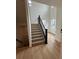 Bright entryway showcasing a modern staircase with hardwood floors and abundant natural light at 203 Washington St, Erie, CO 80516