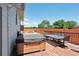 A view of the hot tub and table and chairs on the deck in the backyard of the home at 2800 Troxell Ave, Longmont, CO 80503