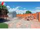 Backyard of home with a shed, playset, rock decor, and an orange fence for privacy at 2800 Troxell Ave, Longmont, CO 80503