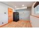 View of basement featuring wood-look flooring, light gray walls and secure gun safe at 2800 Troxell Ave, Longmont, CO 80503