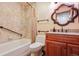Bathroom featuring wood vanity, accent-tiled walls and bath-tub combo at 2800 Troxell Ave, Longmont, CO 80503