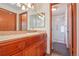 Bathroom featuring warm wooden vanity and sink, with a shower/toilet room attached at 2800 Troxell Ave, Longmont, CO 80503