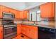 Kitchen with stainless steel appliances, wood cabinets, and granite countertops with tile backsplash at 2800 Troxell Ave, Longmont, CO 80503