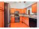Kitchen with stainless steel appliances, wood cabinets, and granite countertops, and wood floor at 2800 Troxell Ave, Longmont, CO 80503