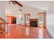 Open living room with vaulted ceilings, wood floors, fireplace, a ceiling fan and natural light at 2800 Troxell Ave, Longmont, CO 80503