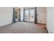 Bright living room featuring a window and a door to an outdoor deck with carpeted floors at 2800 Troxell Ave, Longmont, CO 80503