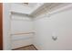 A walk-in closet features wooden and metal rods for clothing storage, and neutral carpet at 2800 Troxell Ave, Longmont, CO 80503