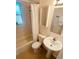 Clean bathroom with a pedestal sink, bathtub, and shower at 799 N Holly St, Denver, CO 80220