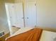 Bedroom with orange bedding, white accents, and hardwood floors at 799 N Holly St, Denver, CO 80220