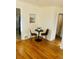 Bright dining area with wood floors, a table with chairs, and convenient access to the kitchen at 799 N Holly St, Denver, CO 80220