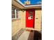 Brick ranch home with a bright red front door at 799 N Holly St, Denver, CO 80220
