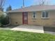 Backyard with red door and brick exterior at 799 N Holly St, Denver, CO 80220