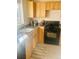 Well-equipped kitchen with granite counters, wood cabinets, black gas range and modern appliances at 799 N Holly St, Denver, CO 80220