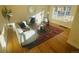 Inviting living room features hardwood floors, a cozy sofa, fireplace and bright natural light at 799 N Holly St, Denver, CO 80220