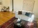 Bright living room with wood floors, area rug, modern sofa, side table and abstract artwork at 799 N Holly St, Denver, CO 80220