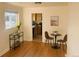 Bright dining area features hardwood floors, a table with chairs, and convenient access to kitchen at 799 N Holly St, Denver, CO 80220