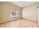 Bedroom features neutral walls, ceramic tile floors, and large window at 9742 E Hawaii Pl, Aurora, CO 80247