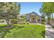Charming home with lush green lawn, mature trees and lovely landscaping creates a welcoming and picturesque setting at 9742 E Hawaii Pl, Aurora, CO 80247