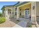 Inviting front porch with well-maintained landscaping, charming details and ample natural light enhance curb appeal at 9742 E Hawaii Pl, Aurora, CO 80247