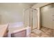 Bathroom features a large soaking tub and shower with glass door at 9742 E Hawaii Pl, Aurora, CO 80247