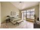 Bright main bedroom boasts a vaulted ceiling, sliding glass doors, and a ceiling fan at 9742 E Hawaii Pl, Aurora, CO 80247