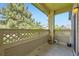 Covered patio with decorative lattice overlooking trees and neighborhood at 9742 E Hawaii Pl, Aurora, CO 80247