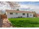 Spacious backyard with green grass, complemented by a white home exterior and wood fence at 9120 Judson St, Westminster, CO 80031