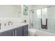 Renovated bathroom features blue vanity, new fixtures, and a glass-enclosed shower at 9120 Judson St, Westminster, CO 80031