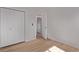 This bedroom has a double door closet, light wood floors, and fresh paint at 9120 Judson St, Westminster, CO 80031