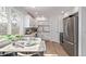 Modern kitchen with stainless steel appliances, light cabinets, and a cozy breakfast nook, filled with sunlight at 9120 Judson St, Westminster, CO 80031