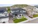 Stunning aerial view of a two-story home with gray siding, a two car garage, and luscious green yard at 359 Rogers Way, Castle Rock, CO 80104