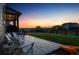 An inviting backyard with a stamped concrete patio, Adirondack chairs, and lush grass, perfect for outdoor relaxation at 359 Rogers Way, Castle Rock, CO 80104