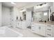 Elegant bathroom with dual vanities, modern fixtures, and a large soaking tub at 359 Rogers Way, Castle Rock, CO 80104